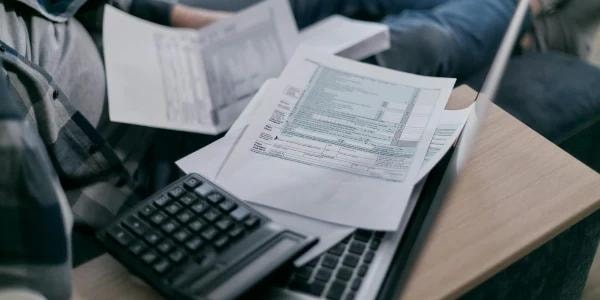 IRS resolutions — reviewing tax documents with calculator